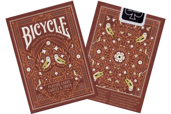 Bicycle Aviary Red Card Deck featuring an intricately designed front and back with floral patterns and birds. The deck is manufactured by US Playing Card Co., suitable for various card games.