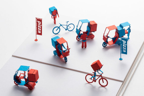 A vibrant Pizza Delivery Model by TERADA MOKEI featuring colorful paper figures in red and blue, including pizza delivery scooters, bikes, and a pizza sign. The intricate details showcase a miniature delivery scene, perfect for DIY enthusiasts.