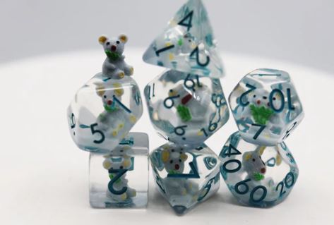 A colorful set of Koala RPG dice featuring six different polyhedral shapes. Each die is clear with vibrant blue, green, and yellow accents, and includes a tiny koala figure on one die. The numbers are clearly visible in bold print, making it easy to read and use during gameplay.