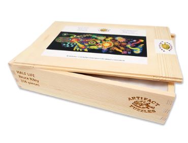 Half Life jigsaw puzzle by Bruce Riley, made by Artifact Wooden Puzzles. The puzzle features colorful, intricate designs and comes in a wooden box displaying the artwork on the lid.