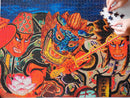 A vibrant 1000-piece jigsaw puzzle featuring an illustration of Japan's Samurai Warrior Festival. The artwork shows fierce warriors with colorful masks and traditional attire, intricately designed, showcasing the cultural celebration. A hand is seen placing a puzzle piece onto the nearly completed image, emphasizing the engaging and immersive experience of assembling this puzzle.