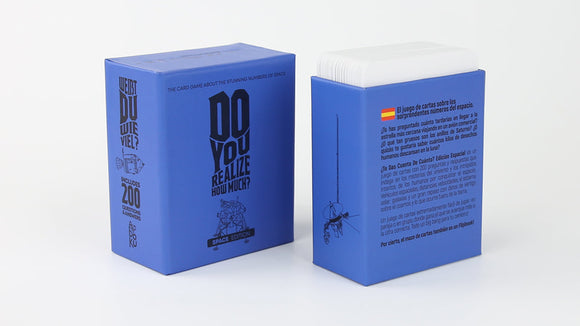 A blue box featuring the game 'Do You Realize How Much: Space Edition' by Boku Flipbooks. The front displays the title prominently in bold black letters against the blue background. The side of the box provides details about the game, including that it includes 200 questions and answers related to space. An illustration of a character is visible on the side, adding a playful touch to the packaging.