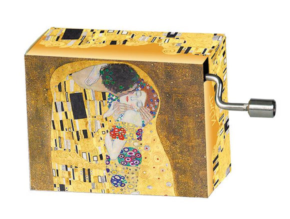 A beautifully designed music box featuring Gustav Klimt's iconic painting 'The Kiss'. The box has a vibrant golden background adorned with intricate patterns, highlighting the romantic embrace depicted in the artwork. The side of the box shows a metal winding mechanism, adding to its charm as a decorative item or a unique gift.