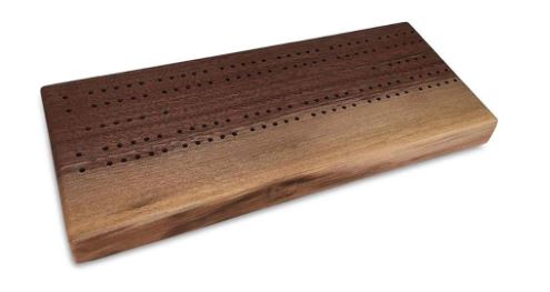 Beautifully crafted walnut live edge cribbage board with smooth finish and distinct grain patterns, featuring scoring holes for game play. Ideal for family game nights and as a decorative piece.