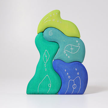 Casa Aqua by Grimm's features uniquely shaped, colorful wooden blocks in shades of green and blue. Each piece is adorned with whimsical white designs resembling natural elements like leaves and bubbles, encouraging creative play and exploration. Ideal for stacking and imaginative construction, this product engages young children's fine motor skills and creativity.