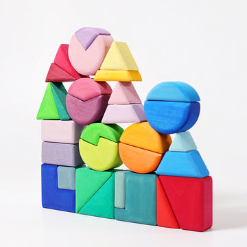 A colorful wooden building set featuring various geometric shapes including triangles, squares, and circles stacked creatively. The pieces are in vibrant shades of pink, blue, green, yellow, orange, and purple, showcasing a playful arrangement that encourages imaginative play and cognitive development in children.