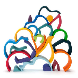 Colorful wooden building set featuring various shaped and curved pieces arranged in a playful structure. The Small Four Elements Building Set by Grimm's emphasizes creativity and imaginative play, with vibrant colors and unique forms that can be stacked or arranged in multiple ways.