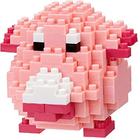 A completed Nanoblock DIY kit featuring Chansey, a pink, blocky animal figure composed of various sized Nanoblock pieces. The figure has a round body, distinct facial features with eyes and a chubby snout, showcasing the intricate design that captures the essence of the character.