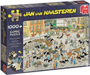 A box of the Cattle Market jigsaw puzzle by Jan van Haasteren featuring a busy comic scene with numerous characters and animals at a market. The puzzle consists of 1000 pieces and showcases a colorful and chaotic illustration filled with cows, people, and various activities.
