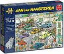 Jumbo Goes Shopping jigsaw puzzle by Jan van Haasteren, featuring a vibrant comic scene of a busy shopping area filled with people, cars, and an elephant in the foreground. The box showcases the colorful artwork and highlights that it is a 1000 piece puzzle.
