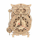 A detailed 3D wooden owl clock kit featuring intricate cog designs and Roman numerals. The owl has large expressive eyes and a classic clock face with a pendulum feature. Made from quality wood, this DIY kit offers a creative building experience and a functional, decorative timepiece once completed.