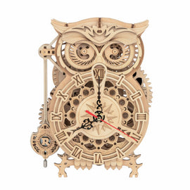 A detailed 3D wooden owl clock kit featuring intricate cog designs and Roman numerals. The owl has large expressive eyes and a classic clock face with a pendulum feature. Made from quality wood, this DIY kit offers a creative building experience and a functional, decorative timepiece once completed.