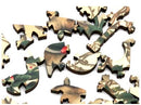 Close-up of intricately designed jigsaw puzzle pieces featuring a nature theme with birds and greenery. The pieces are made of quality wood with detailed prints.