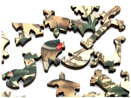 Close-up of intricately designed jigsaw puzzle pieces featuring a nature theme with birds and greenery. The pieces are made of quality wood with detailed prints.