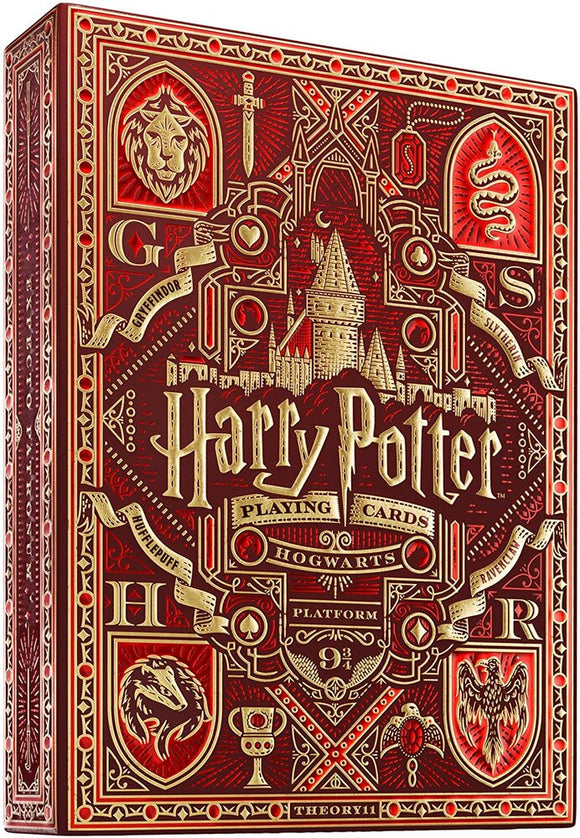 A beautifully designed box of Harry Potter playing cards in red and gold colors featuring symbols associated with Hogwarts houses. The design includes a lion for Gryffindor, a snake for Slytherin, and a badger for Hufflepuff, along with intricate patterns and the iconic Hogwarts castle. The title 'Harry Potter' is prominently displayed at the top, making it a perfect collectible for fans of the series.