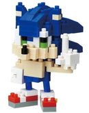 A detailed image of a Nanoblock DIY kit featuring Sonic the Hedgehog. The miniature figure showcases Sonic's iconic blue spiky hair, green eyes, and dynamic pose, designed with colorful Nanoblock pieces. The character is depicted with a mischievous expression, showcasing the charm of this beloved video game icon.