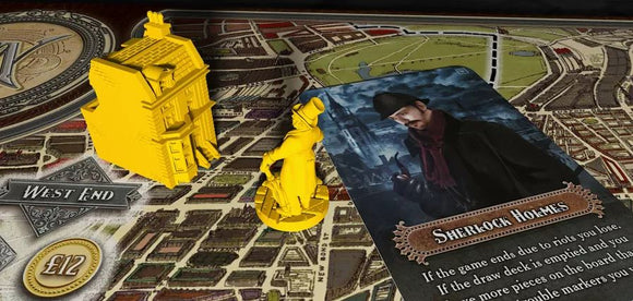 The Nanty Narking Regular Edition game setup featuring a detailed yellow miniature building and a character figurine depicting Sherlock Holmes next to a game card on a richly illustrated game board. The board hints at a Victorian London map theme.