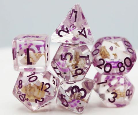 A set of seven RPG dice featuring a vibrant purple and clear design with embedded koi fish details. The polyhedral dice include various shapes like D20, D12, D10, D8, D6, D4, and a percentile die, all adorned with black numbers for easy readability, perfect for tabletop gaming enthusiasts.