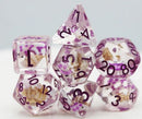 A set of seven RPG dice featuring a vibrant purple and clear design with embedded koi fish details. The polyhedral dice include various shapes like D20, D12, D10, D8, D6, D4, and a percentile die, all adorned with black numbers for easy readability, perfect for tabletop gaming enthusiasts.