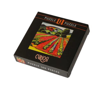 Q Puzzle Art2: Q1-7 jigsaw puzzle by Curiosi featuring a vibrant image of a landscape with colorful fields. The box contains 166 pieces, designed for puzzle enthusiasts.