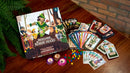 Rescuing Robin Hood board game from CASTILLO GAMES displayed on a wooden table. The game box features colorful artwork with characters from the Robin Hood legend. Surrounding the box are various game components, including character cards, tracking cards, tokens, and colorful game pieces, creating an inviting setting for family and friends to enjoy together.