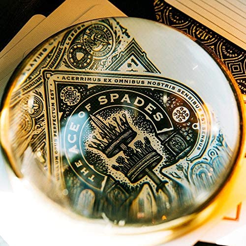 Close-up view of the High Victorian card deck by Theory 11, showcasing the intricately designed Ace of Spades card through a decorative lens. The ornate details highlight the craftsmanship and artistic style of the deck, perfect for card enthusiasts and collectors.