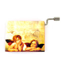 A beautifully crafted music box featuring an image of two cherubic angels from Raphael's artwork. The music box has a metal winding mechanism on the side, ideal for decorative purposes or as a nostalgic gift.