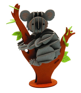 A colorful 3D paper model of a koala clinging to a brown tree trunk, featuring intricate details like textured leaves and the koala's cute facial features. This DIY kit allows for creative assembly and adds a charming decorative touch.