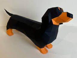 A colorful, low-poly model of a dachshund crafted from geometric shapes. The model features a black body with orange accents on the feet and face, emphasizing its playful character. Ideal for DIY enthusiasts and pet lovers, this craft kit allows for hands-on creation and adds a fun decorative touch to any space.