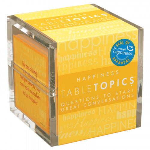 A clear acrylic cube containing 'Happiness Table Topics' game from Table Topics. The cube is bright yellow, featuring inspiring quotes and prompts to encourage engaging conversations about happiness. The product emphasizes positivity and connection.