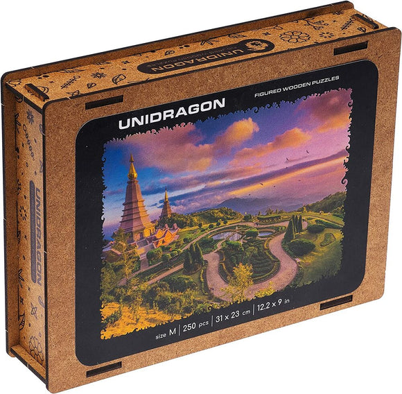 Chiang Mai - Medium jigsaw puzzle by Unidragon featuring a serene landscape with tiered temples, vibrant greenery, and a colorful sunset sky. The puzzle box displays the image and detailed specifications including size and number of pieces.