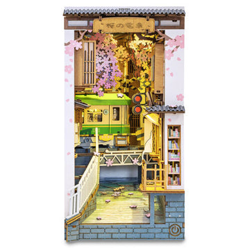 The Sakura Tram DIY Book Nook by Robotime features a vibrant miniature scene with cherry blossoms, a vintage tram, and intricate details inside a cozy nook. Perfect for DIY enthusiasts, this kit allows users to build a charming bookshelf insert that showcases a fusion of nature and urban life.