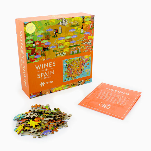 Wines of Spain & Portugal jigsaw puzzle by Ginger Fox. The box features colorful map illustrations of wine regions in Spain and Portugal, with a pile of puzzle pieces scattered in front. A pamphlet titled 'World Leader' provides information about the puzzle.