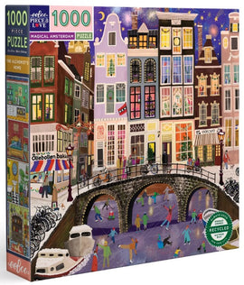1000-piece jigsaw puzzle titled 'Magical Amsterdam' by Eeboo, showcasing a vibrant winter scene in Amsterdam with colorful houses, a frozen canal where people are ice skating, and holiday decorations adorning the streets.
