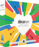 Decorum is a vibrant and colorful game box featuring a heart-shaped design made from various colored segments. The title 'décorum' is prominently displayed in the center, showcasing a playful palette. The design is modern and eye-catching, hinting at a cooperative and creative gaming experience where players engage in expressive construction.