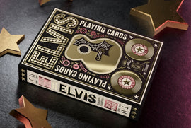 Elvis Playing Cards by Theory 11 featuring a beautifully designed box with intricate graphics. The box showcases Elvis's iconic imagery, including a guitar motif and decorative floral elements. The color scheme includes gold and black, enhancing its vintage appeal. Ideal for card games and collectors alike.