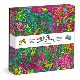 Colorful box of the I Love My Hair jigsaw puzzle designed by Andrea Pippins, featuring vibrant illustrations of hair, flowers, and shapes, with a label detailing it as a 500 piece puzzle with 15 shaped pieces.