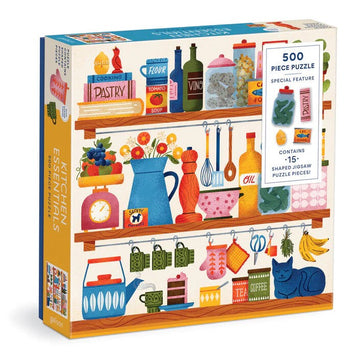 Kitchen Essentials jigsaw puzzle by Galison featuring a colorful illustration of kitchen items on shelves. The puzzle includes 500 pieces, with 15 special shaped jigsaw pieces representing various kitchen elements like pots, flowers, and food containers, creating a vibrant and playful kitchen scene.