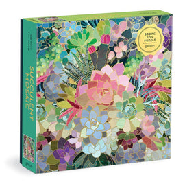 A 500-piece jigsaw puzzle titled 'Succulent Mosaic' by Galison. The puzzle features a vibrant, colorful array of succulents and tropical plants in a mosaic design, all adorned in shiny foil. The packaging is bright green with detailed illustrations and is designed to engage puzzle enthusiasts and nature lovers alike.
