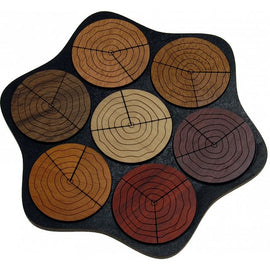 Jahresringe (Growth Rings) mechanical puzzle featuring circular wooden pieces resembling growth rings, arranged on a textured black base. The pieces vary in color and design, creating a visually appealing and challenging puzzle.