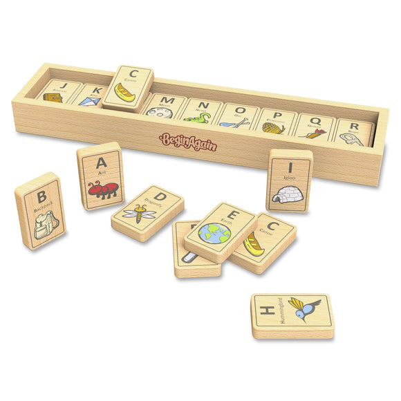A colorful set of wooden Alphabet Adventure Tiles from Begin Again. The tiles feature letters A-Z with illustrations representing each letter, such as 'Ant' for A, 'Bee' for B, and 'Canoe' for C. The tiles are neatly arranged in a wooden storage box, showcasing the educational and playful design, perfect for young learners to enhance their alphabet recognition and vocabulary.