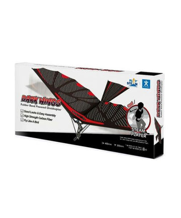 The Dark Wings Rubber Band Powered Ornithopter by PlaySTEAM is showcased in its colorful packaging. The box features illustrations of the ornithopter in action, highlighting its sleek design and robust structure made from high-strength carbon fiber. Notable points on the package emphasize easy assembly and the joy of flight, suitable for ages 8 and up.