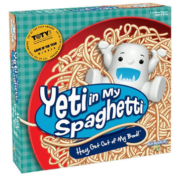 The 'Yeti In My Spaghetti' game box by PlayMonster features a playful white yeti character sitting in a bowl of spaghetti. The vibrant red and blue design showcases the title prominently, with additional text saying, 'Hey Get Out of My Bowl!' It highlights that the game is suitable for 2 or more players aged 4 and up. This family-friendly game promises fun and laughter as players try to free the yeti from the tangled noodles.
