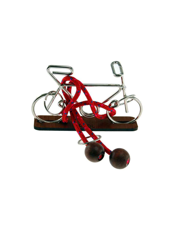 Radl mechanical puzzle from Jean-Claude Constantin featuring a detailed metal bicycle design with a red lacing mechanism and wooden base. Ideal for puzzle enthusiasts, this intricate toy offers a challenging and engaging hands-on experience.
