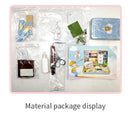 Display of Happiness Theater DIY kit by Guangzhou Hongda Craft Co., Ltd. showing a variety of materials including a tin box, miniature accessories, tools, and papers for creating a detailed scene.