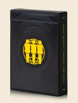 Third Man Records Card Deck by Art of Play, featuring a sleek black design with an embossed pattern and a yellow logo depicting three figures within a globe, ideal for card games or as a collectible item.