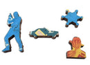 A close-up of pieces from the 'Gunfight on the Roof' jigsaw puzzle by Jim Flora, featuring colorful wooden shapes like a blue figure holding a gun, a blue car, a sheriff star, and a yellow figure. Each piece showcases vibrant artwork and unique designs, adding artistic flair to puzzle-making.