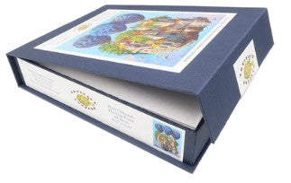 Floating Town jigsaw puzzle by Roch Urbaniak, featuring vibrant artwork of a whimsical town scene with colorful balloons. The puzzle comes in a navy-blue box, showcasing its unique design.