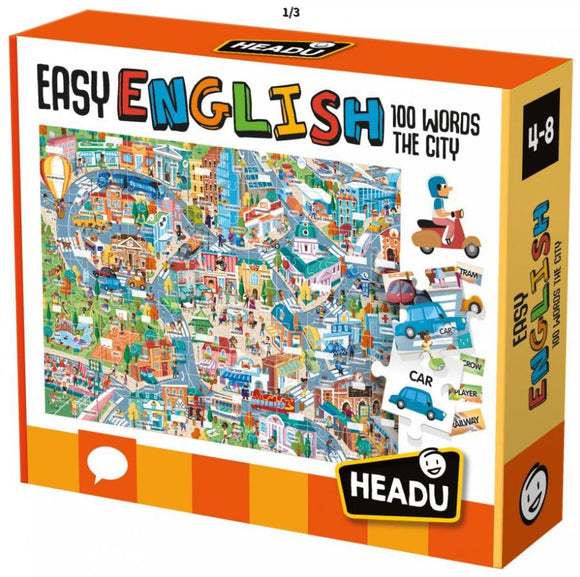 The Easy English 100 Words City jigsaw puzzle from Headu features a colorful and detailed illustration of a bustling city scene. The box showcases various vehicles like cars and trams, along with numerous buildings, people, and activities, making it an engaging educational tool for children aged 4-8 to learn vocabulary through play.