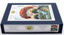 A jigsaw puzzle titled 'Pride of Peacocks' by Marie Amalia, created by Artifact Wooden Puzzles. The image shows the puzzle box featuring vibrant, detailed artwork of peacocks amidst whimsical trees and lush greenery. The box is navy blue with a clear depiction of the completed puzzle on the front, emphasizing its artistic design.